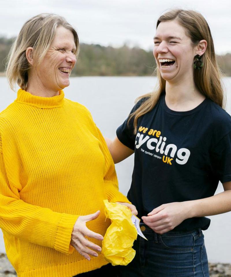 A staff member with a volunteer laughing