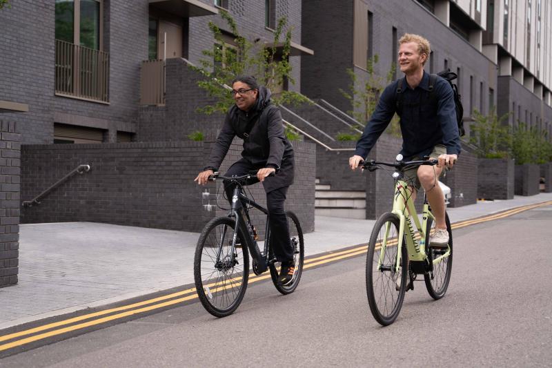 Two friends riding an e-bike