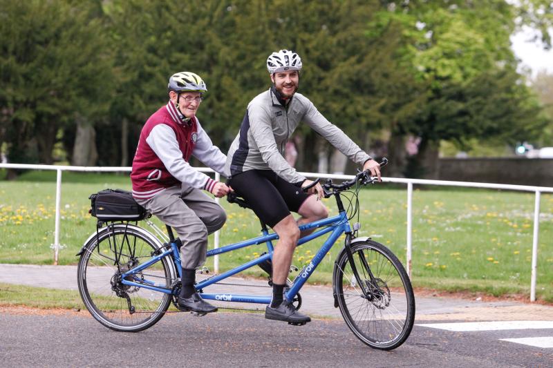 Two men cycling on a tandem