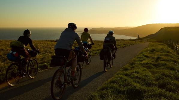 Image of people cycling  the Cantii Way at sunset