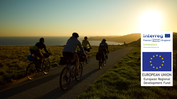 People cycling along the coast at sunset