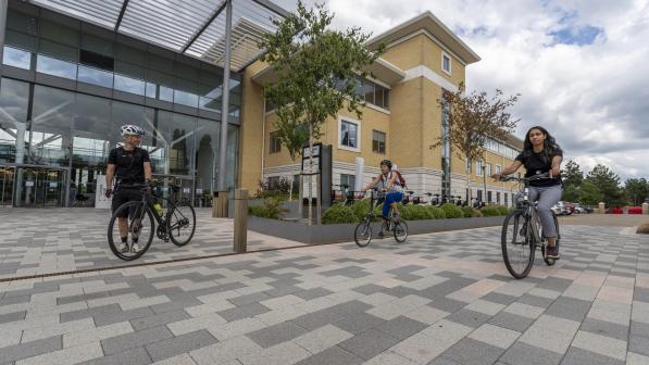 People with bikes outside an office building