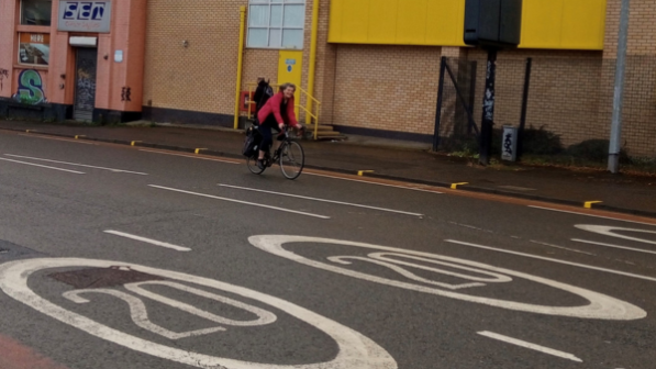 Cycling UK staff member Gwenda Owen cycling on a 20mph road in Cardiff