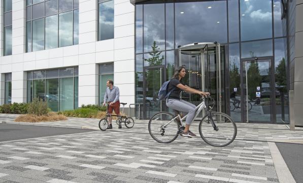 Cyclist riding past an office entrance