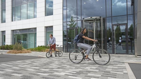 Cyclist riding past an office entrance