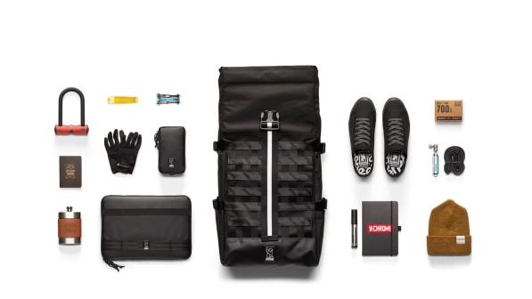 The black Barrage Cargo backpack with contents including lock, gloves, notebook, shoes, hat, laptop and bike repair tools