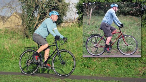 A man in cargo shorts, long-sleeved top and cycle helmet is riding a black touring bike with a drop bar on a mud track. Inset: the same man is riding a red flat-bar touring bike on a track