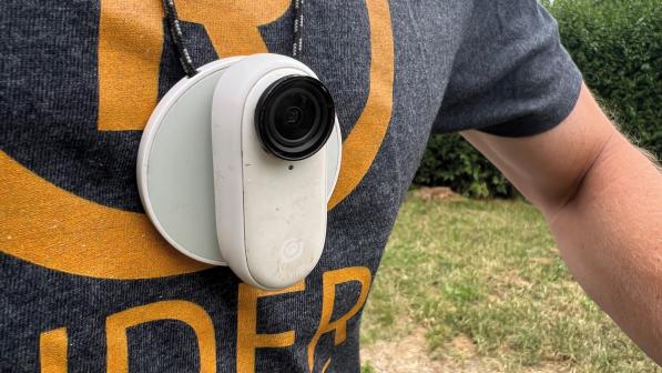 A white cycling camera worn around the neck