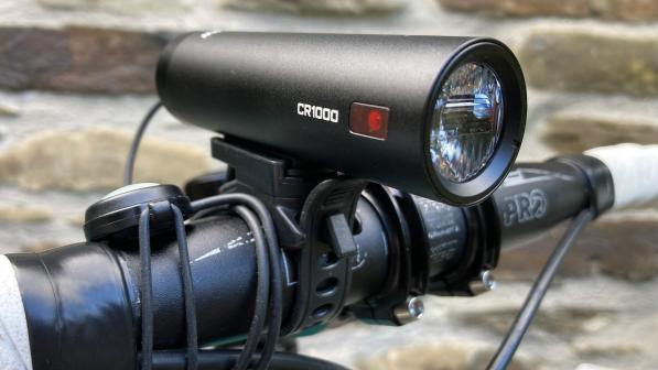 Ravemen CR1000 front headlight attached to bike handle bars