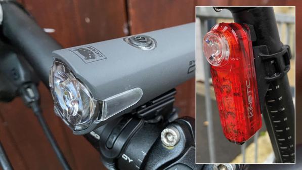 CatEye Sync Core front light mounted to a bike handlebar with the Sync Kinetic rear light mounted to a seatpost inset with a white border around the edges