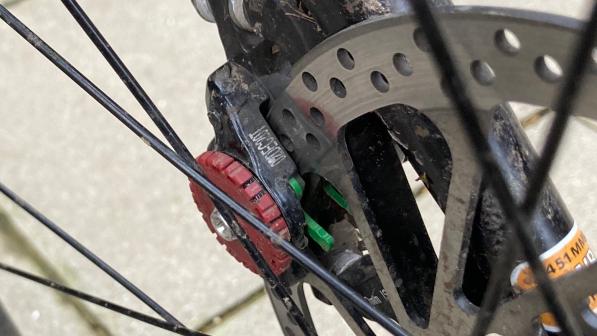 A close-up shot of the rear wheel of a mountain bike showing the disc brakes