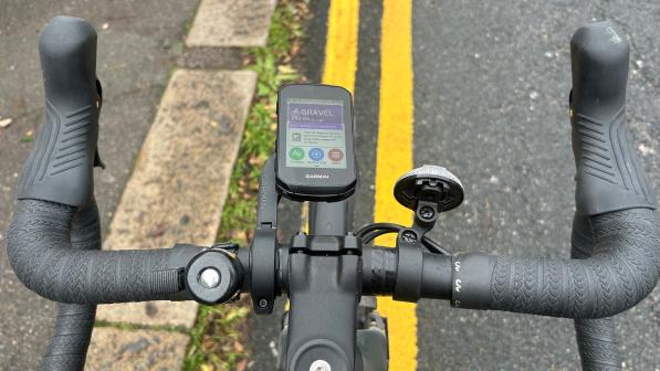 Garmin Edge 850 attached to a black mount holding it out in front of the handlebar in alignment with the stem