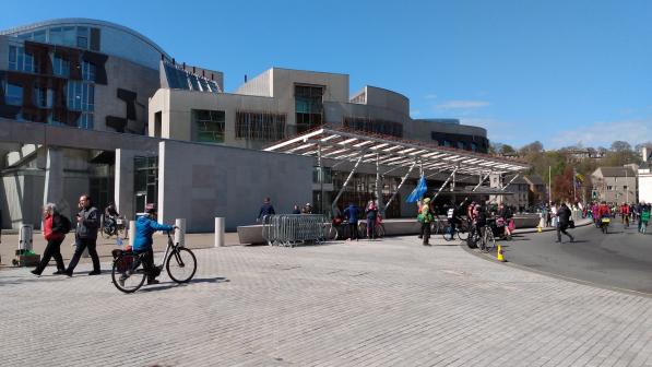 Scottish Parliament Building Holyrood with people walking and cycling outside