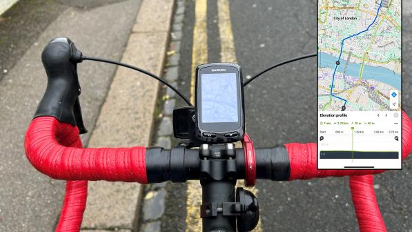 A close-up of a bike drop handlebar with a Garmin bike computer attached, showing a route. There's also an inset of the same route on a phone using Komoot