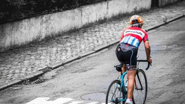 A female cyclist riding up hill