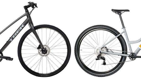 Two step-through hybrid bikes, a black one from Trek on the left, a grey one from Islabikes on the right