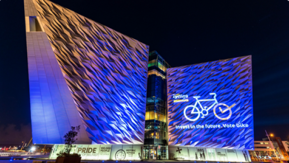 A projection on the Titanic Museum in Belfast with the pro-cycling message "Invest in the future. Vote bike"