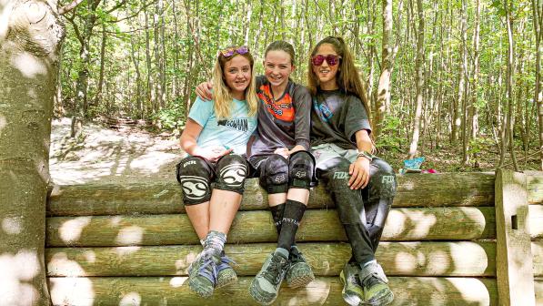 Eme sat with friends she's made whilst racing and riding mountainbikes 