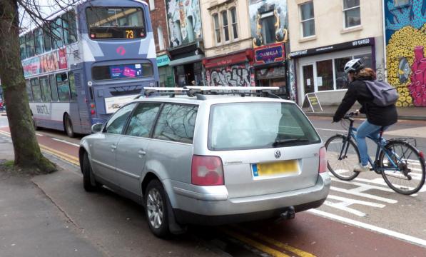 A car is parked in a mandatory cycle lane. Photo by Sam Saunders