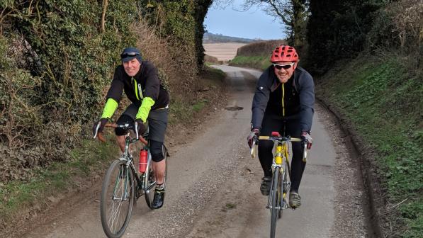 Two cyclists on a country lane