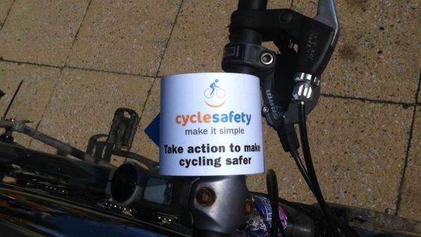 A Cycle safety: make it simple handlebar flyer attached to bicycle