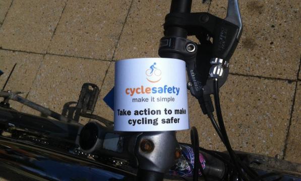 A Cycle safety: make it simple handlebar flyer attached to bicycle