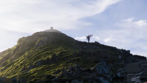 Lone cyclist heading up Mount Snowdon in the early morning
