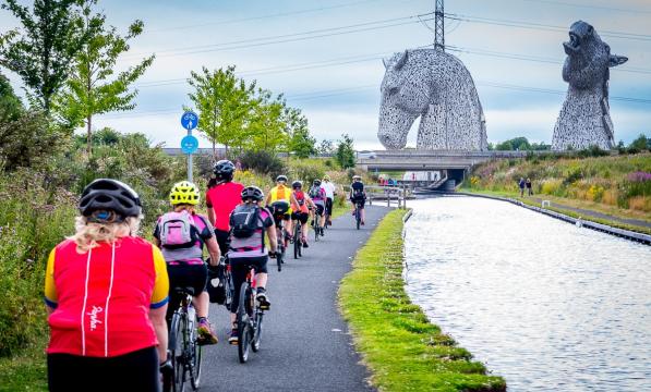Participants riding past the Kelpies in Falkirk on the Belles Big Ride