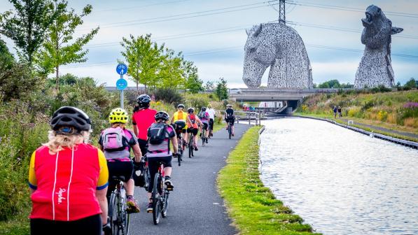 Participants riding past the Kelpies in Falkirk on the Belles Big Ride