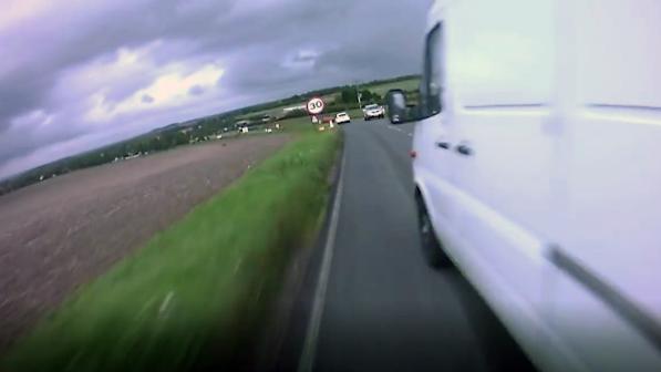 A van close passes a cyclist