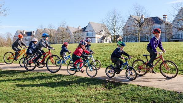 Children cycling in park