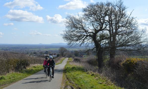 Two cyclists on a country lane