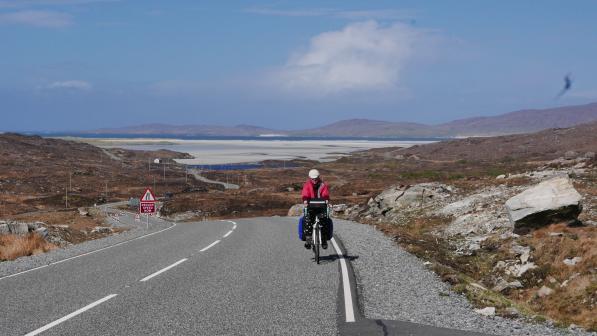 Cyclist riding up from the sands of Luskentyre