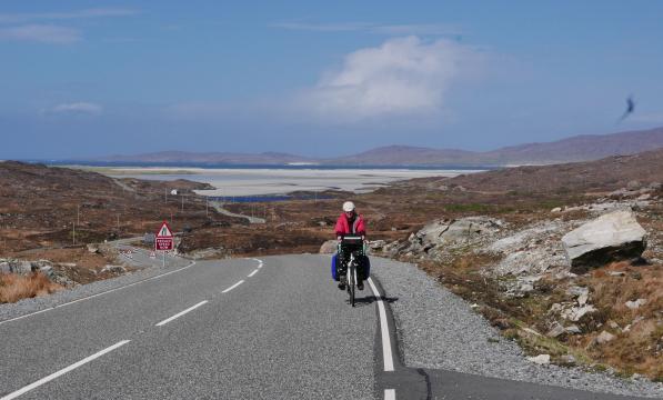 Cyclist riding up from the sands of Luskentyre