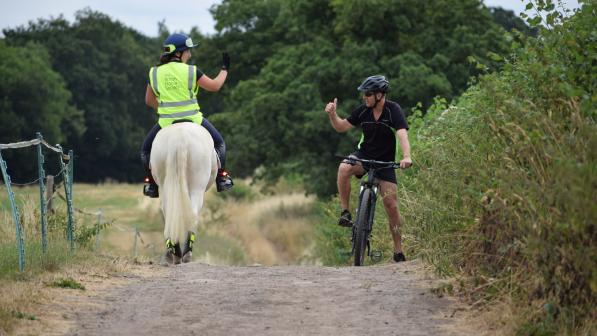 Cyclist and horse rider passing 