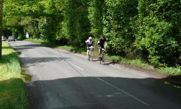 Two cyclists on a country lane