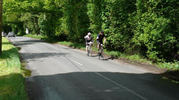Two cyclists on a country lane
