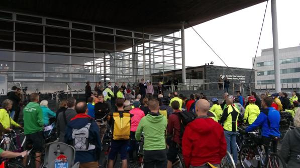 Cyclists gather on the steps of the Senedd