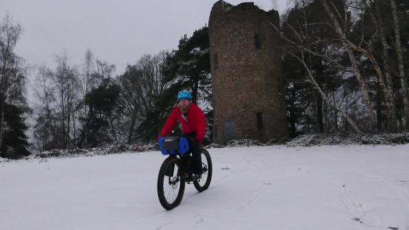 Cyclist bikepacking in the snow 