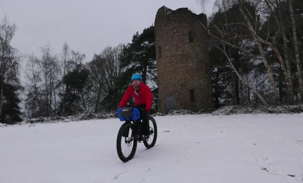 Cyclist bikepacking in the snow 