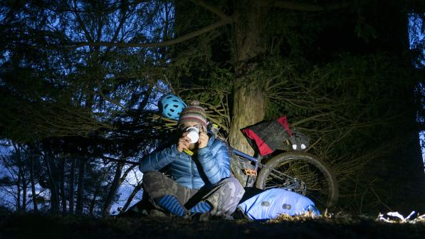 Bikepacking cyclist having a cup of tea 