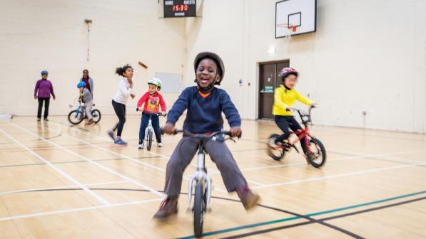 Child riding balance bike