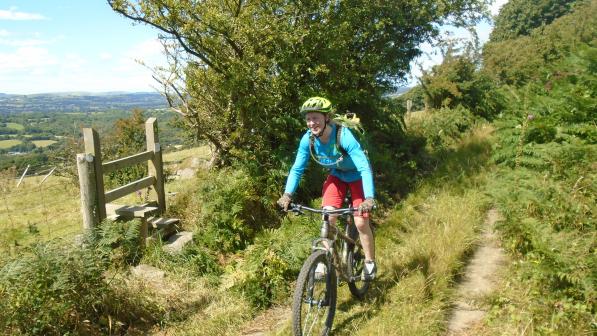 Woman cycling off-road in Wales