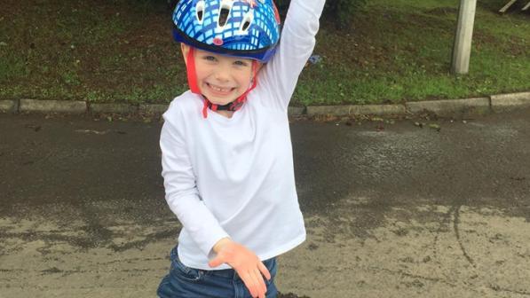 A child with bike smiling