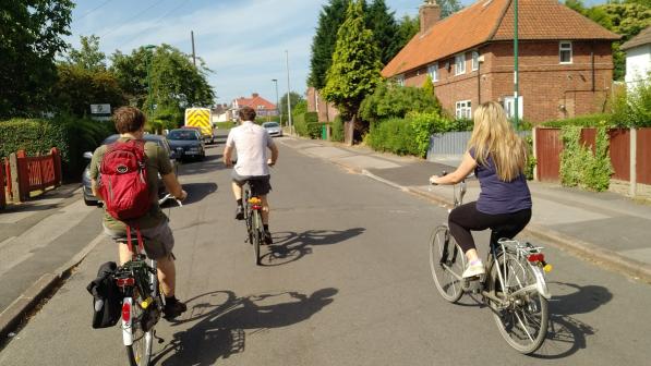 Group of friends cycling on a residential street in Nottingham