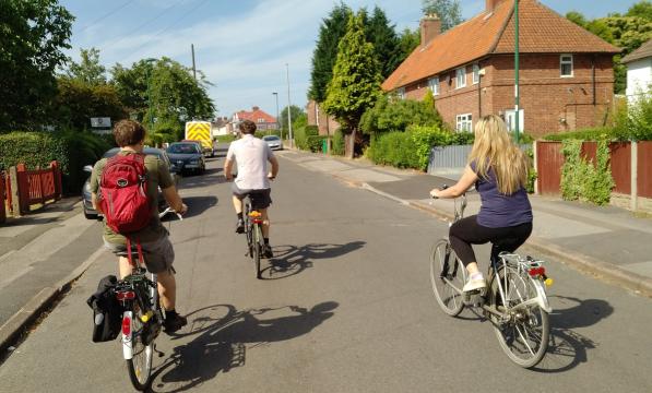 Group of friends cycling on a residential street in Nottingham