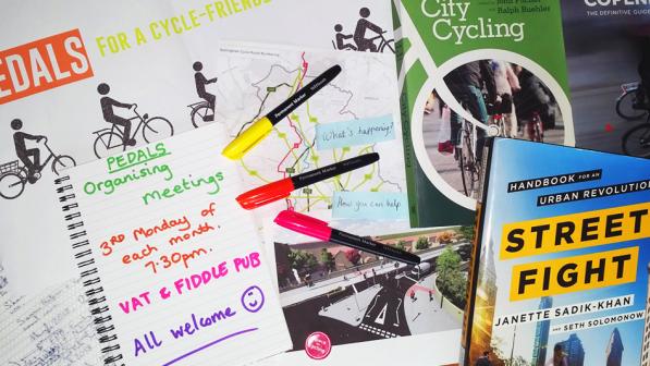 Photo of cycle campaigning books, pens and paper