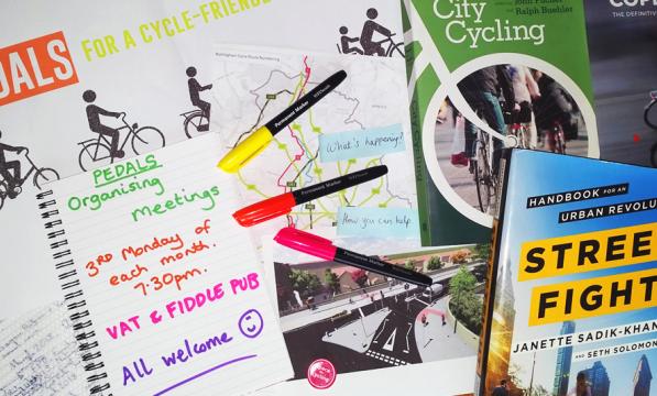 Photo of cycle campaigning books, pens and paper