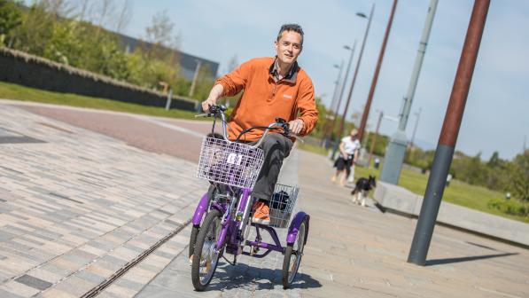 Ian Tallach rides an e-trike