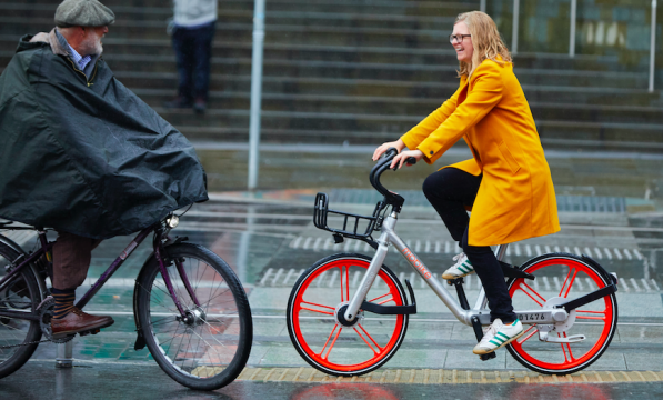 Helen Pidd riding a Mobike in the rain